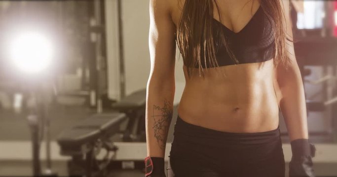 Cinematic body portrait of active fitness woman's waist and well trained stomach