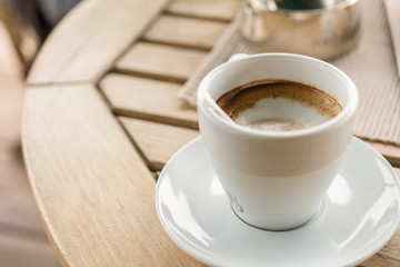 Cup of coffee on wooden background.Close up shoot