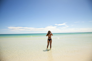 Fototapeta na wymiar girl with black bikini on a beautiful beach