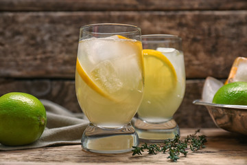 Fototapeta premium Refreshing cocktails with lemon on wooden table