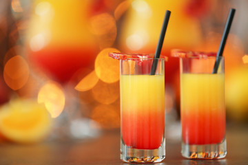 Delicious tequila sunrise cocktails on bokeh lights background