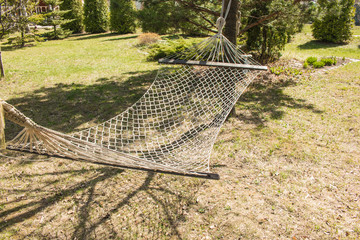 Hammock on the trees in the spring garden
