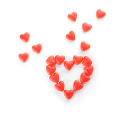 Composition of heart-shaped jelly candies on white background