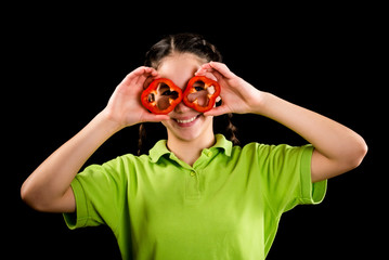 funny girl with sliced paprika on eyes