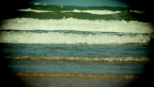 Sea serf time lapse on rugged sandy beach  