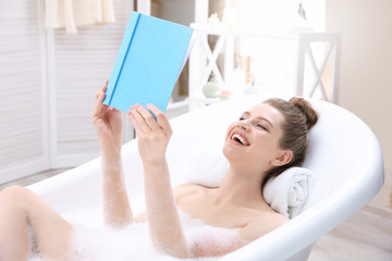 Obraz na płótnie Canvas Beautiful young woman taking bath at home