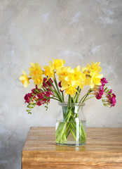 Vase with beautiful flowers on table