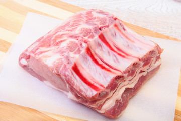 Raw pork chops, spices on cutting board. Ready for cooking.