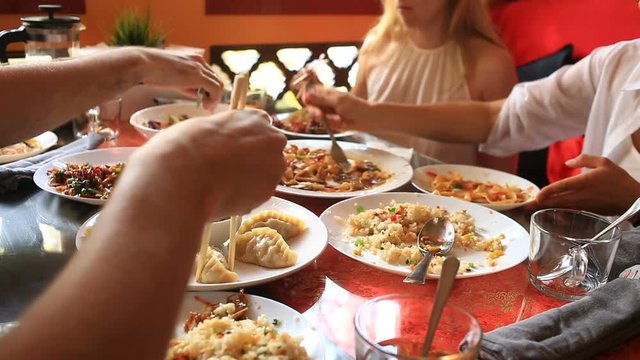 Friends Eat Chinese Food In A Chinese Restaurant