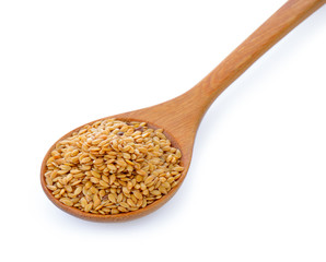 Flax seeds heap in wood spoon isolated on white background