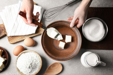 Woman making dough for a pie in bowl