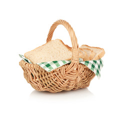 Wicker basket with fresh bread on white background