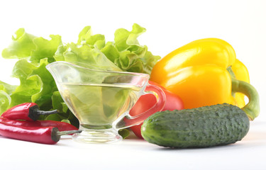 Assorted vegetables, fresh bell pepper, tomato, chilli pepper, cucumber, olive oil and lettuce isolated on white background. Selective focus.