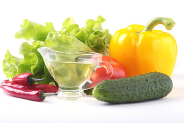 Assorted vegetables, fresh bell pepper, tomato, chilli pepper, cucumber, olive oil and lettuce isolated on white background. Selective focus.