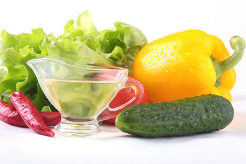 Assorted vegetables, fresh bell pepper, tomato, chilli pepper, cucumber, olive oil and lettuce isolated on white background. Selective focus.