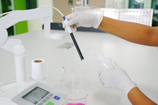 The scientist work at the chemical solution with pH meter
