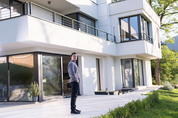 man in front of his luxury home villa