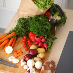 Grocery shopping bag with vegetables on kitchen