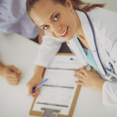 Doctor woman sitting with  male patient at the desk