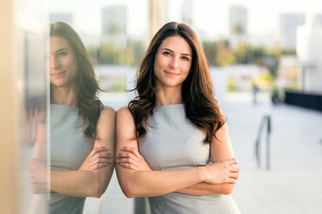 Confident new modern professional female standing at business location, shop owner entrepreneur