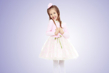 Elegant little girl in a pink dress.