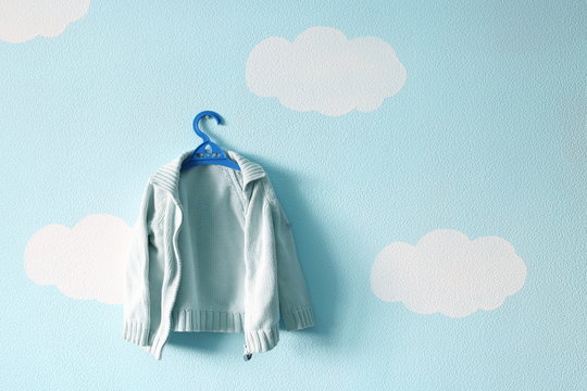 Baby Sweater On The Beautiful Blue Wallpaper