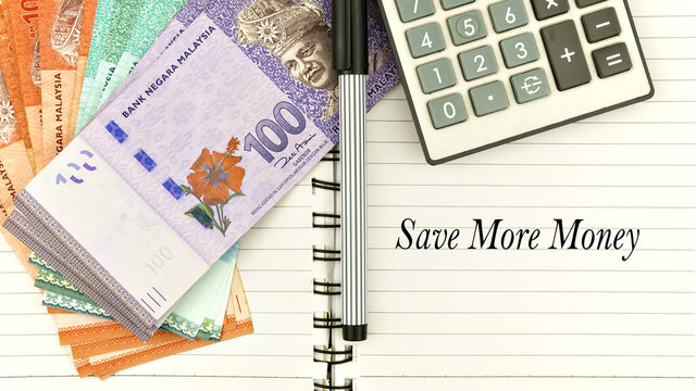 conceptual image with cash, calculator and notepad with word " save more money"