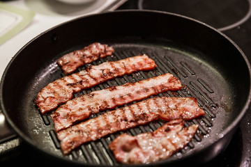 Bacon frying on a stove