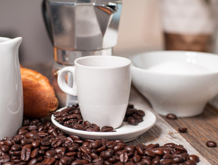 Cup of coffee and coffee pot on wood table