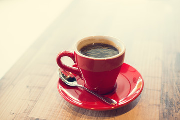 Hot black coffee on table. Vintage filter