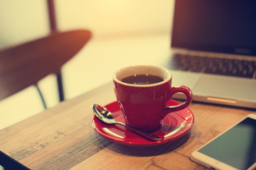 laptop and black coffe in vintage tone