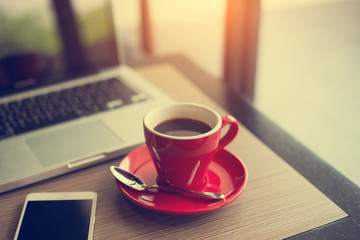 laptop and black coffe in vintage tone