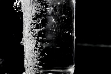 Splash of water on black, Stylish water splash. Isolated on black background, bubbles in the glass,