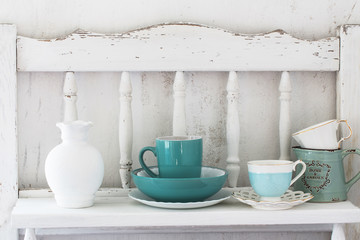  dinnerware on white wooden shelf