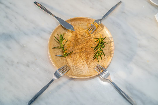 Dirty Dish With Fork And Knife On White Table