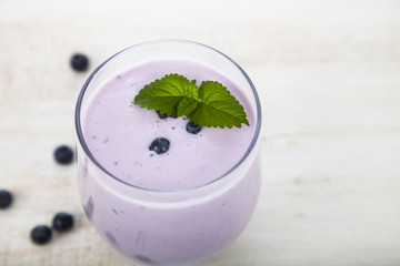 Blueberry yogurt on a wooden table .