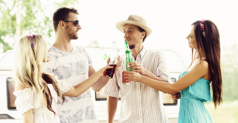 Happy friends having a party outdoors at summer. Holiday, party, vacation concept.