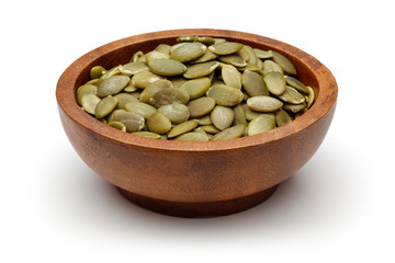 Pumpkin seeds in wooden bowl