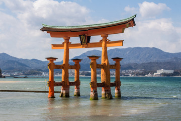 Orange floating Toji at Itsukushima and Miyajima Shinto Shrine outside Hiroshima, Japan on a bright...