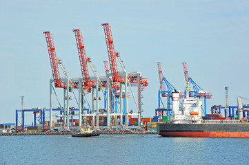Fototapeta premium Tugboat assisting bulk cargo ship
