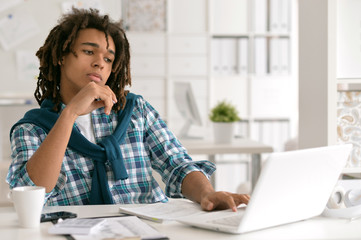 Young business man with laptop working 