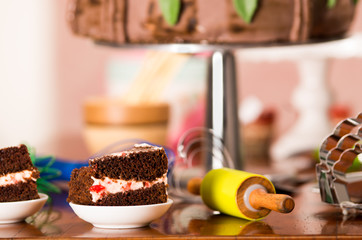 Delicious chocolate cake pieces with cream filling sitting on small plates, pastry concept