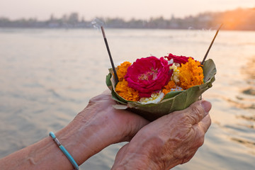 Doing puja at the river Ganges in India at sunset