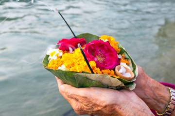 Doing puja at the river Ganges in India at sunset