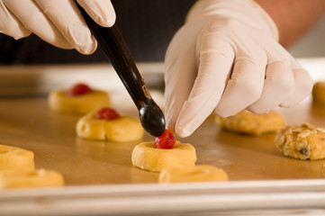 Bakery man preparing delicious christmas cookies in a bakery store