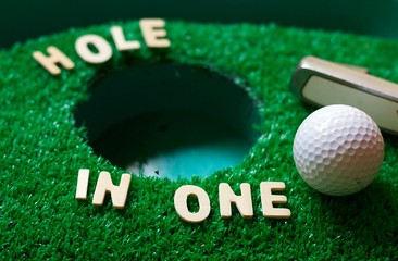 Hole in one on green grass