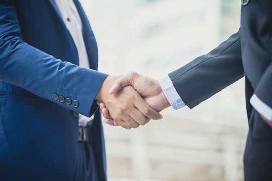 Businessman shake hand together, agreement business concept, vintage color tone