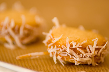 Closeup of a cookie with caramelized milk dulce de leche and coconut, Argentine Cookies Alfajores