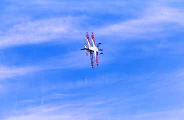 Flight of a sport aircraft against a blue sky.