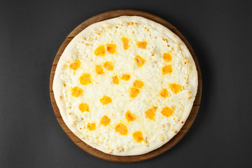Hot pizza on a rustic wooden table.